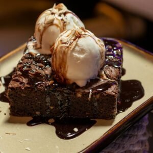 chocolate cake with white icing on white ceramic plate