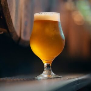 A glass of beer sitting on top of a table