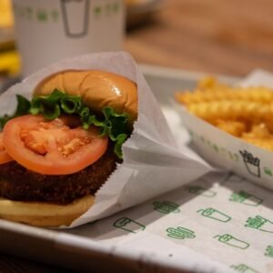 burger with sliced tomato on tray